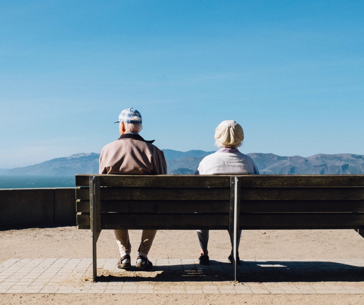 An older couple on a park bench