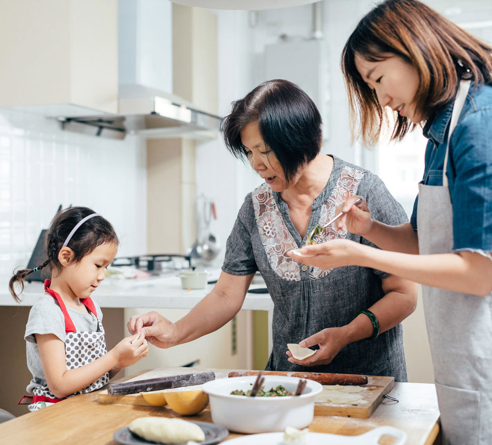 Little girl and her mother cooking with grandma